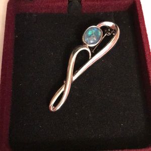 Silver brooch with blue gem